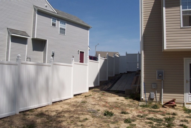 White Vinyl Sectional Privacy Fence on Slope (reverse view)