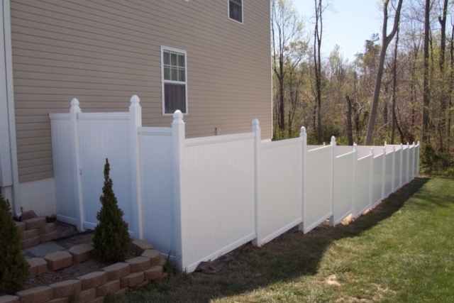 White Vinyl Sectional Privacy Fence on Slope