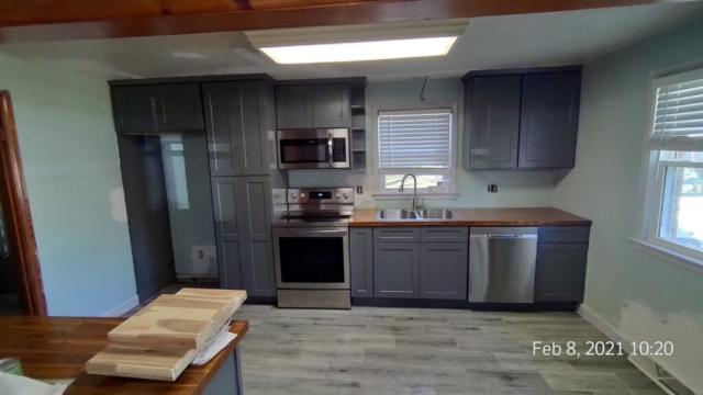 Kitchen Cabinets Mounted, Appliances and Sink Installed