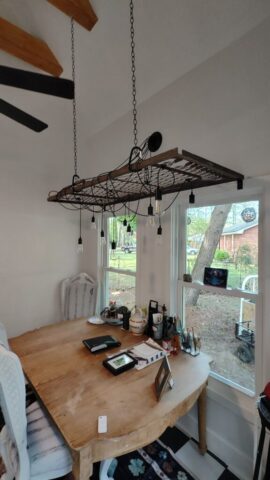Repurposed Army Cot Serving as Lighting Support